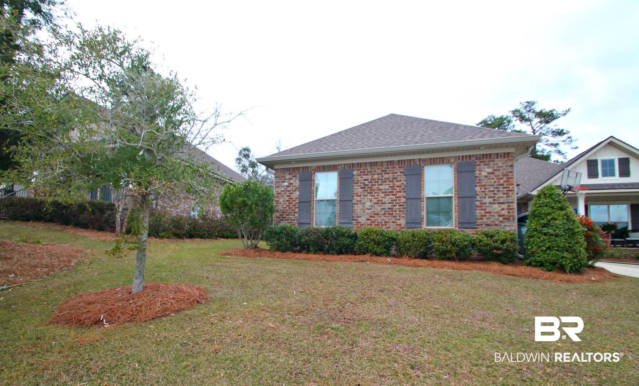 30232 Persimmon Drive Daphne, AL 36527 - Photo 27 of 27 View of front facade with roof with shingles, a front lawn, and brick siding