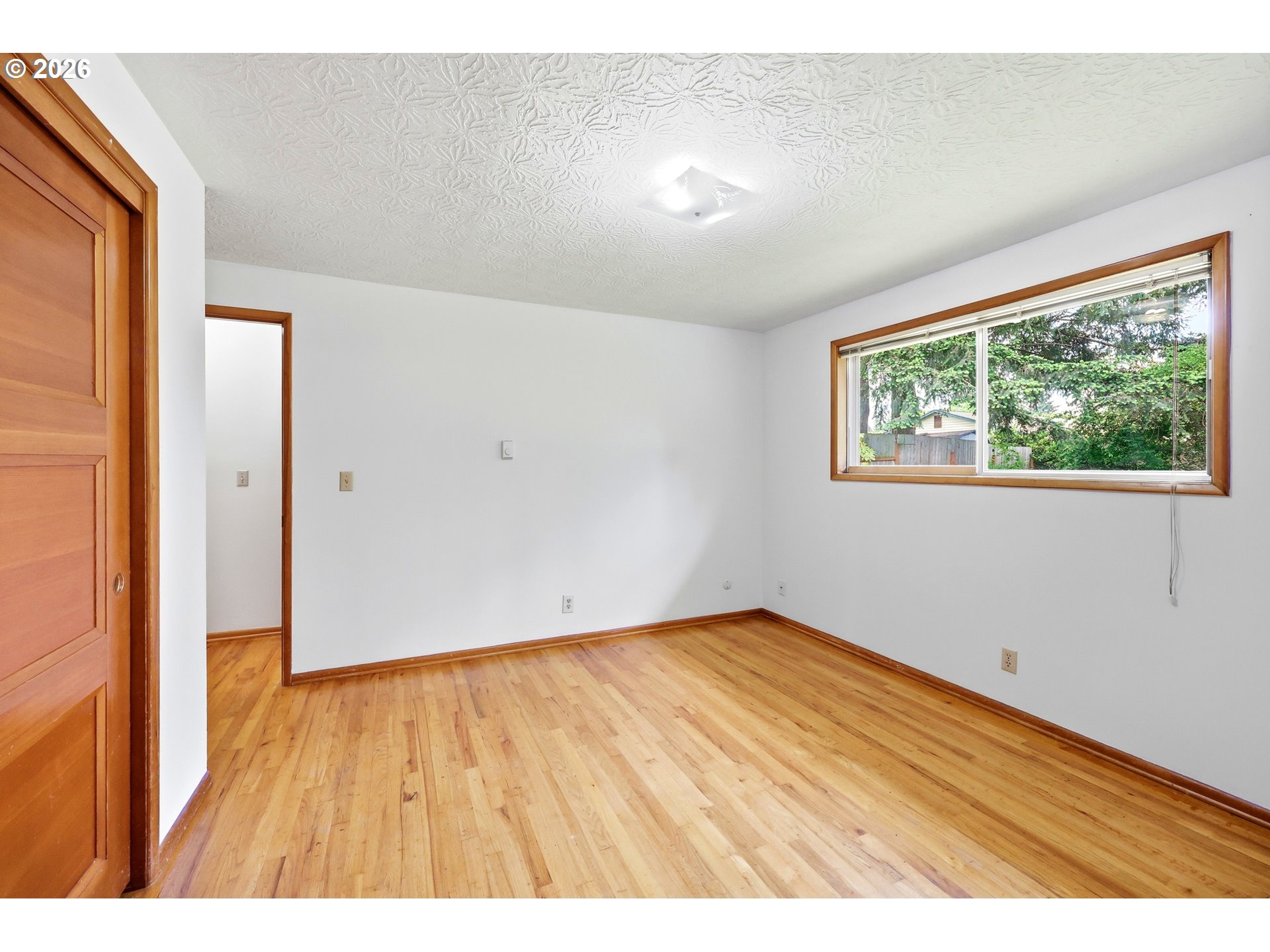 3003 Southeast 162nd Avenue Portland, OR 97236 - Photo 20 of 41 a view of an empty room with wooden floor and a window
