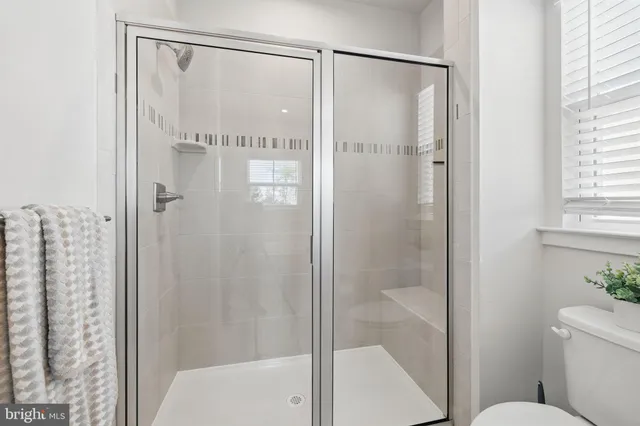a bathroom with a granite countertop bathtub a sink and mirror
