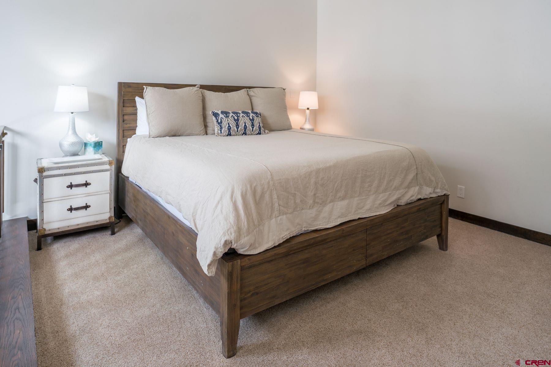 314 Tamarron Drive, Unit 342 Durango, CO 81301 - Photo 15 of 17 a bed sitting in a bedroom and lamp