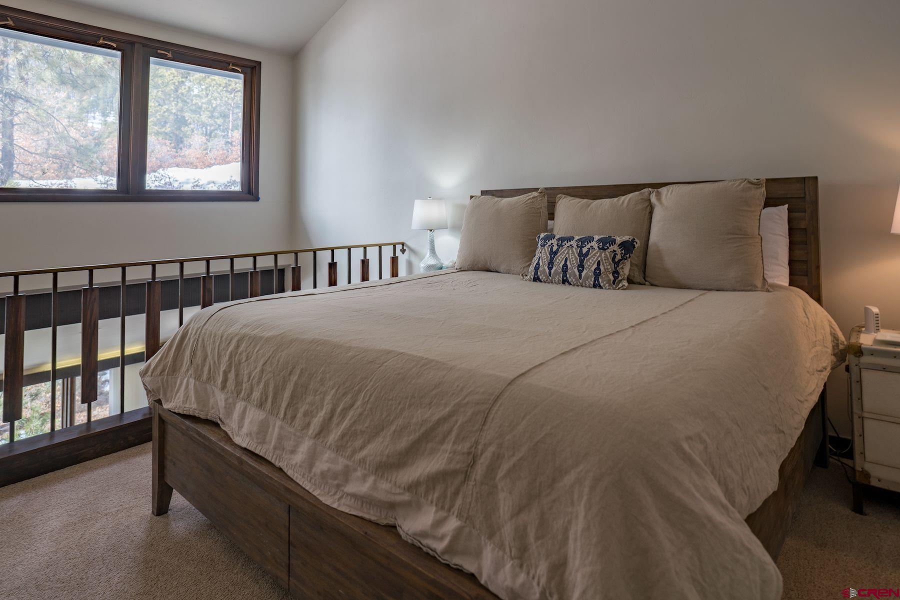 314 Tamarron Drive, Unit 342 Durango, CO 81301 - Photo 16 of 17 a bed sitting in a bedroom next to a window