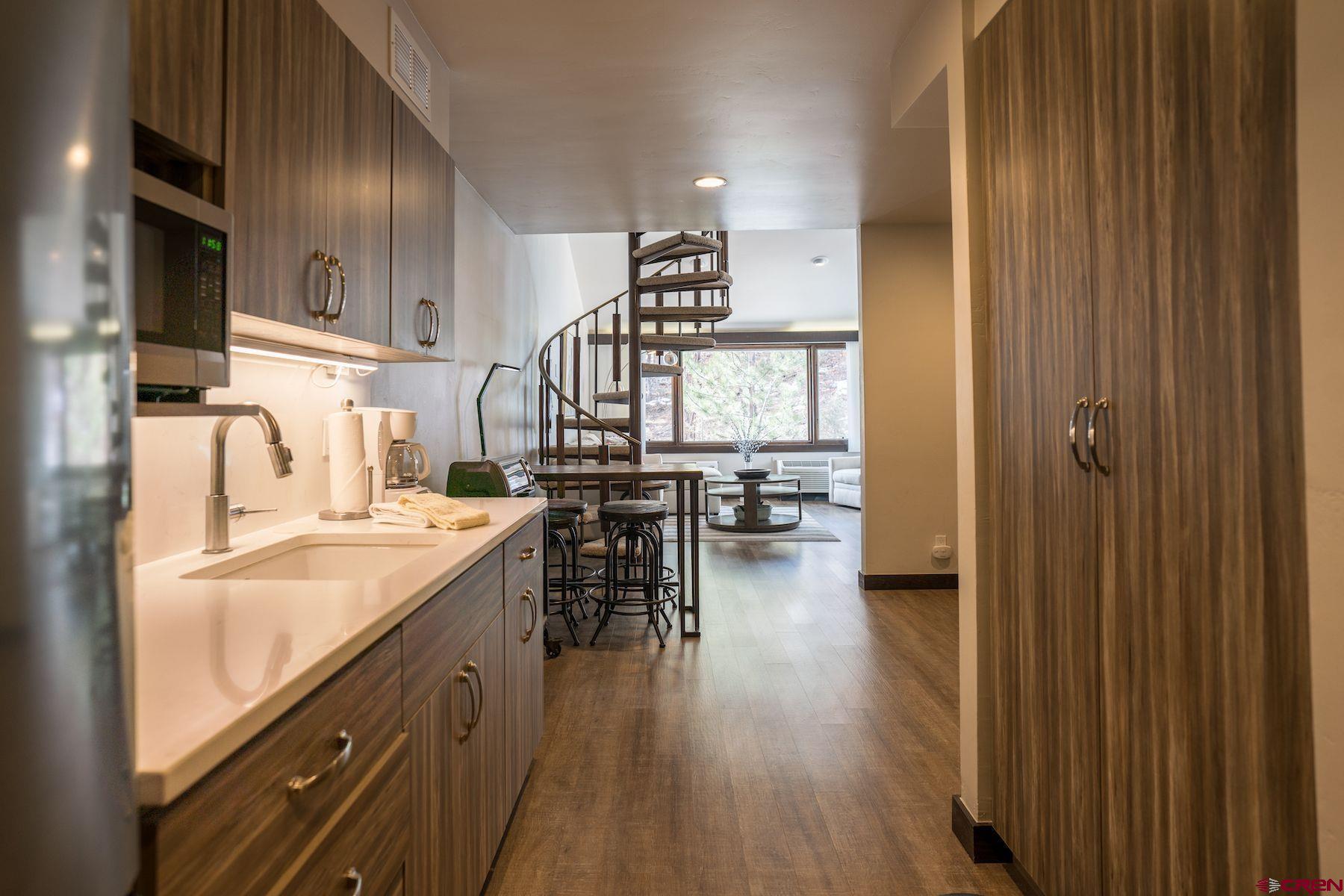 314 Tamarron Drive, Unit 342 Durango, CO 81301 - Photo 2 of 17 a kitchen with sink cabinets and wooden floor