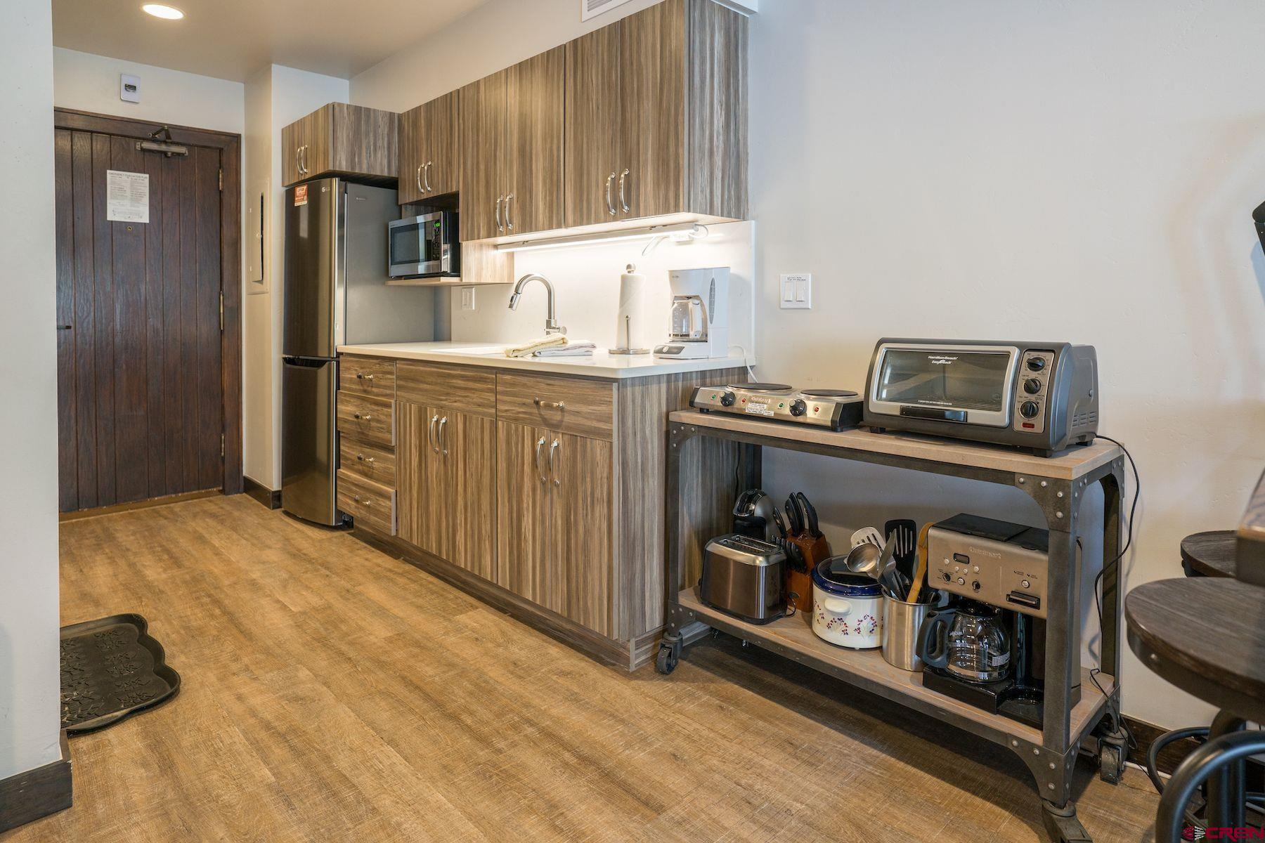 314 Tamarron Drive, Unit 342 Durango, CO 81301 - Photo 3 of 17 a kitchen with stainless steel appliances granite countertop a refrigerator a stove a sink and a cabinets