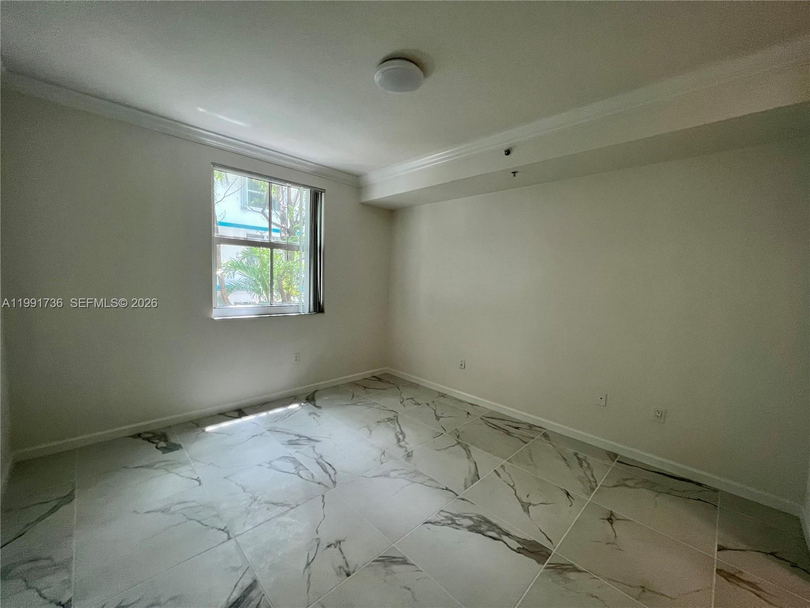 9172 Collins Avenue, Unit 214 Surfside, FL 33154 - Photo 11 of 33 an empty room with windows