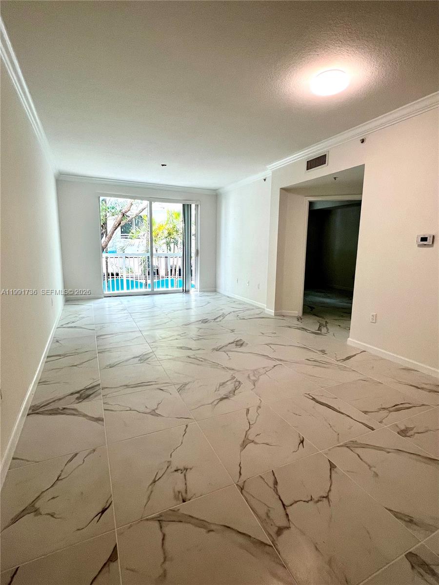 9172 Collins Avenue, Unit 214 Surfside, FL 33154 - Photo 12 of 33 an empty room with windows