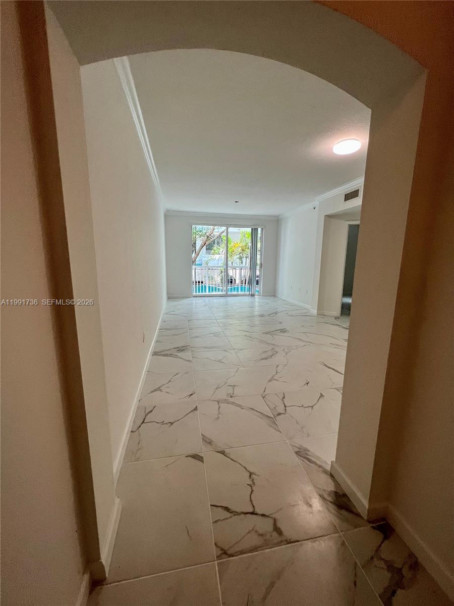 9172 Collins Avenue, Unit 214 Surfside, FL 33154 - Photo 13 of 33 a view of entryway with window and hardwood floor