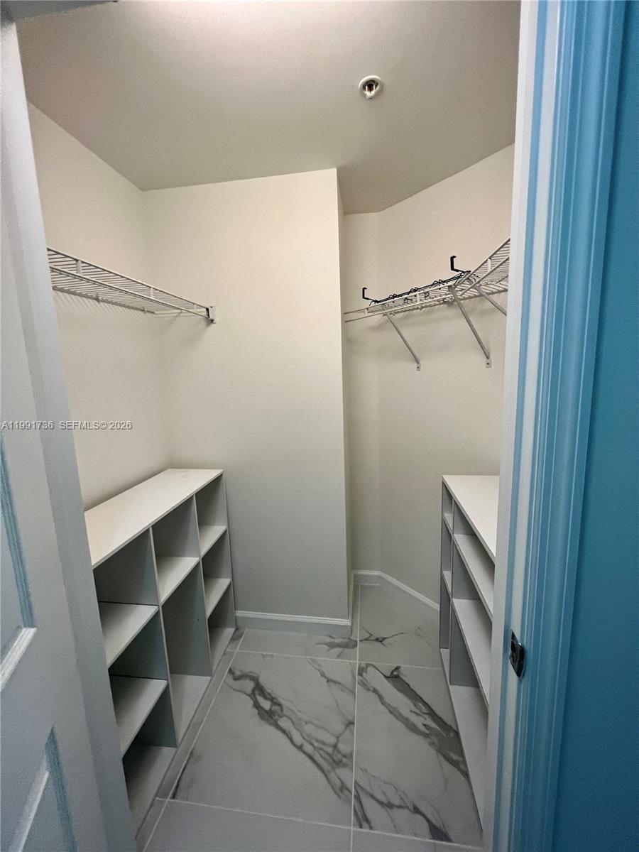 9172 Collins Avenue, Unit 214 Surfside, FL 33154 - Photo 20 of 33 a bathroom with a shower and a sink