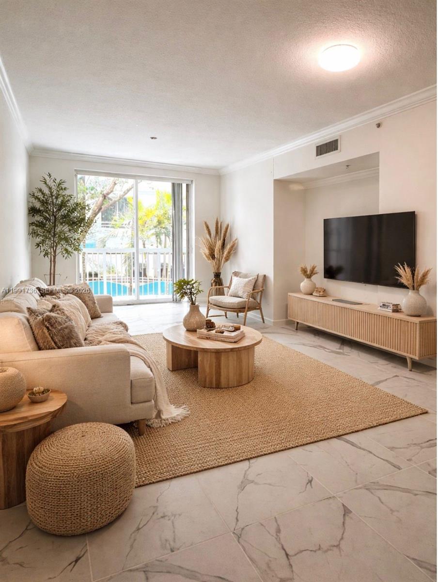 9172 Collins Avenue, Unit 214 Surfside, FL 33154 - Photo 2 of 33 a living room with furniture and a flat screen tv