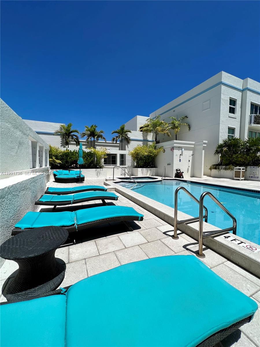9172 Collins Avenue, Unit 214 Surfside, FL 33154 - Photo 29 of 33 a view of a chairs and tables in the patio