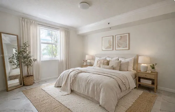 a bedroom with a large bed and a window