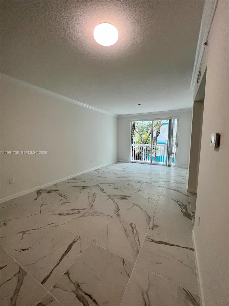 9172 Collins Avenue, Unit 214 Surfside, FL 33154 - Photo 9 of 33 an empty room with windows
