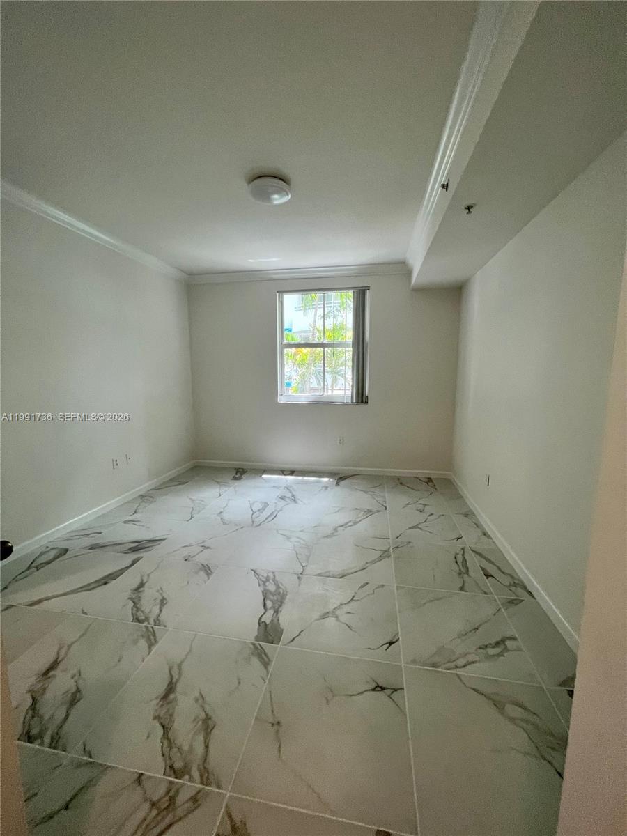 9172 Collins Avenue, Unit 214 Surfside, FL 33154 - Photo 10 of 33 an empty room with windows