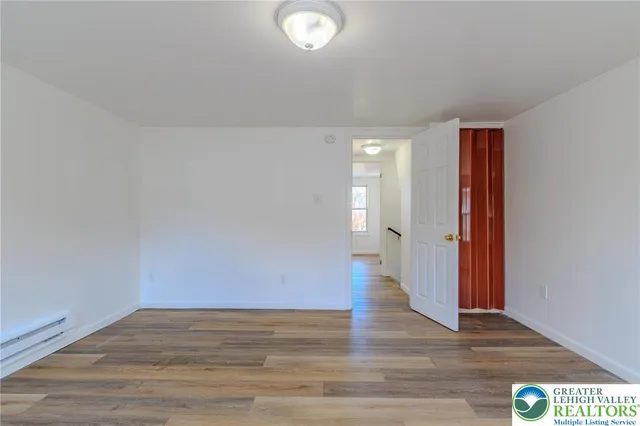a view of an empty room and wooden floor