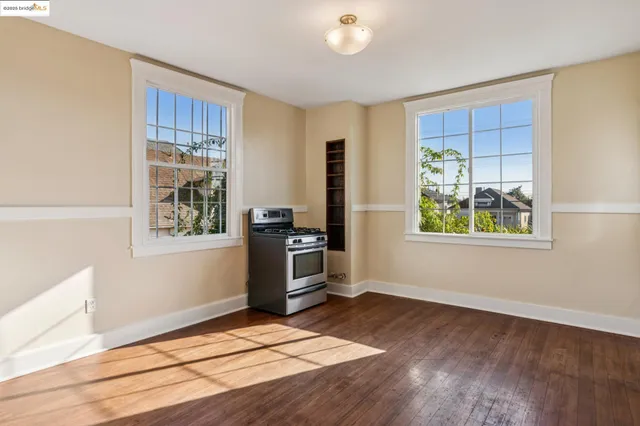 a kitchen with wooden floors and appliances