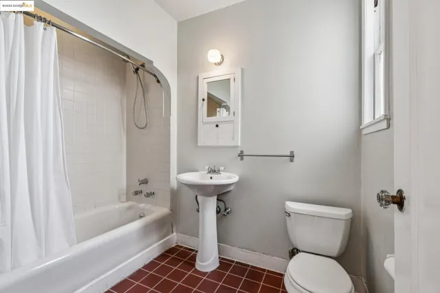 a kitchen with granite countertop a sink and a refrigerator