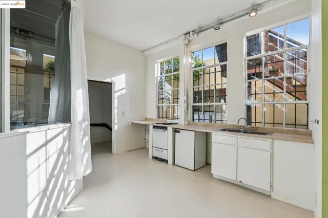 a kitchen with stainless steel appliances granite countertop a stove and a refrigerator