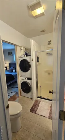 a bathroom with a toilet a sink and a mirror