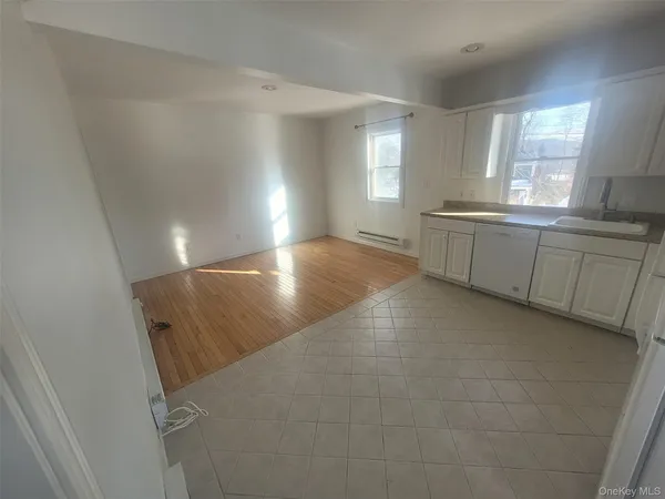 a view of a kitchen with a sink and window