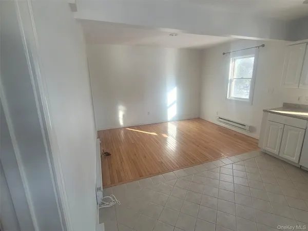 a view of a hallway to rooms and stairs