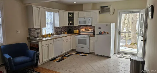 a kitchen with stainless steel appliances a refrigerator sink and cabinets