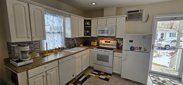 a kitchen with a sink cabinets and window