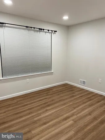 a view of a room with wooden floor and cabinet
