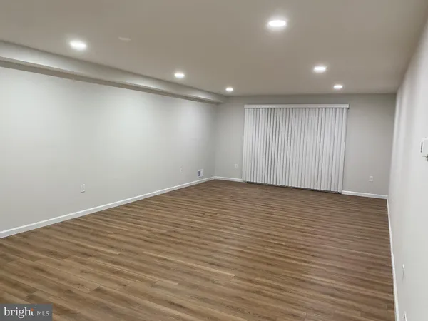 an empty room with wooden floor