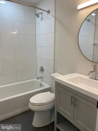 a bathroom with a sink a toilet and bathtub