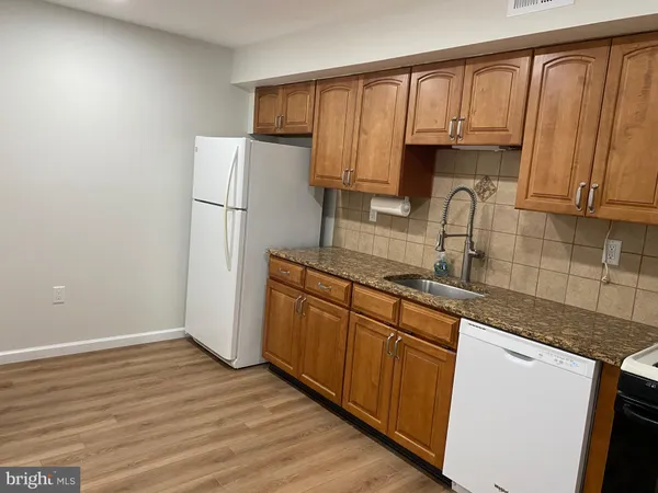 a kitchen with stainless steel appliances granite countertop a refrigerator sink and cabinets