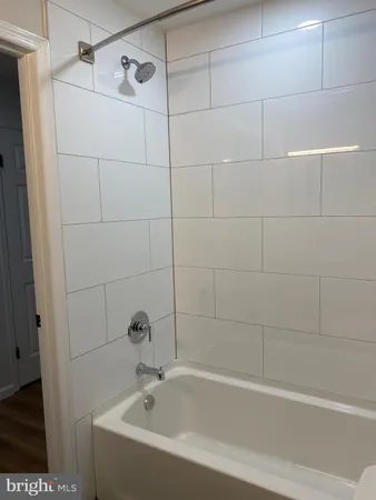 a white bath tub and shower