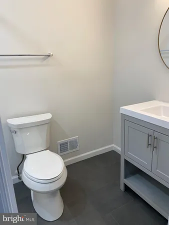 a white toilet sitting next to a bathroom sink