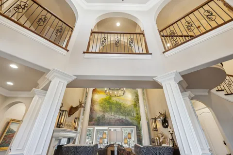 a living room with furniture and a chandelier