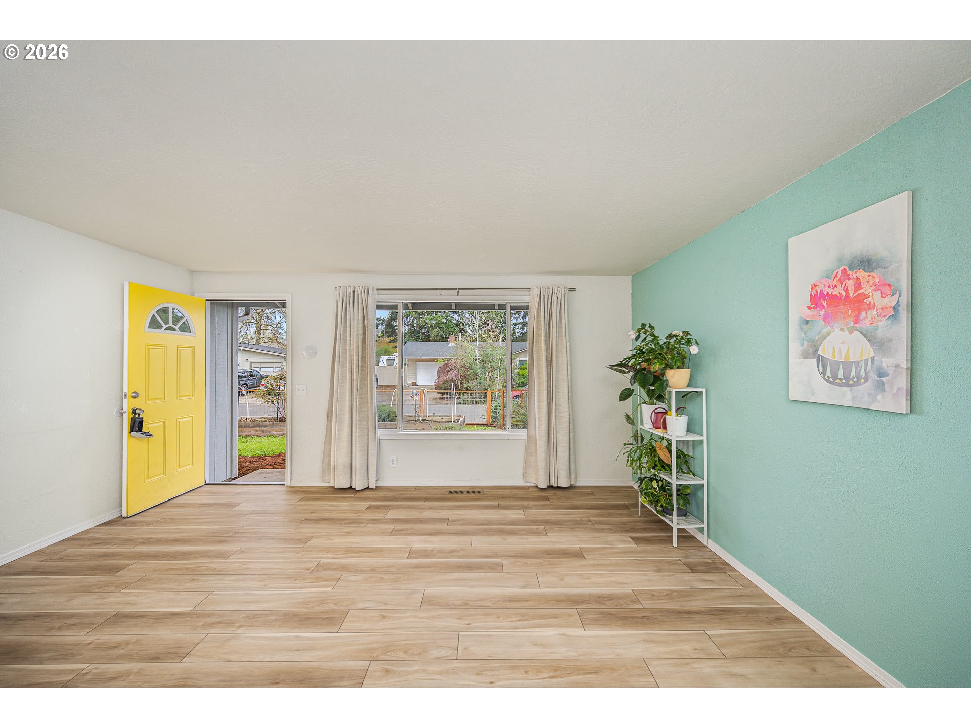 425 Autumn Avenue Eugene, OR 97404 - Photo 4 of 40 a view of an empty room with window and wooden floor