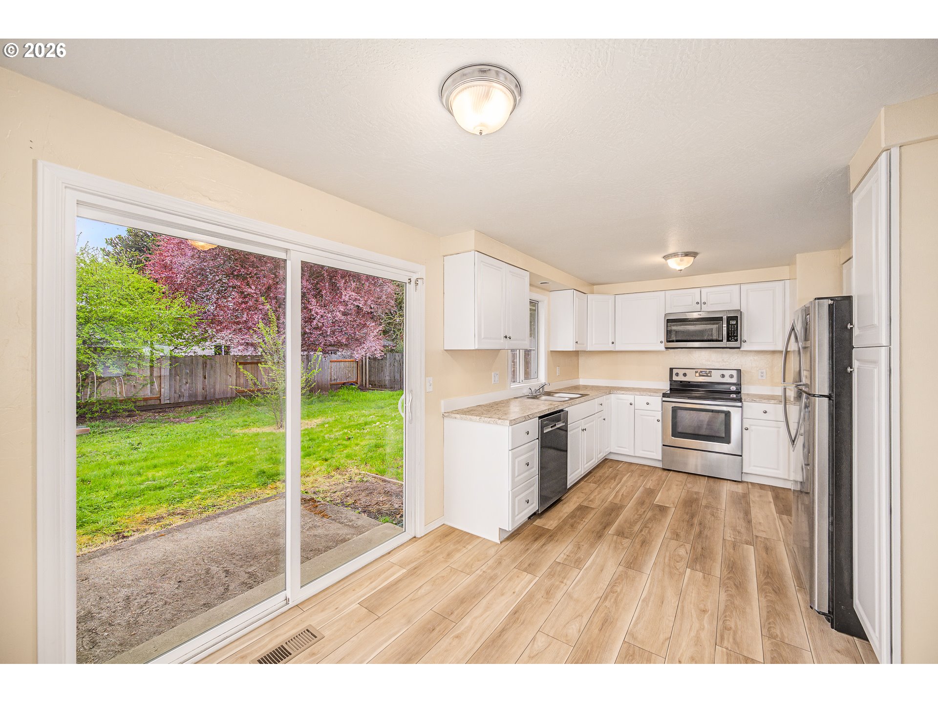 425 Autumn Avenue Eugene, OR 97404 - Photo 7 of 40 a open kitchen with granite countertop a stove top oven a sink and a wooden floors