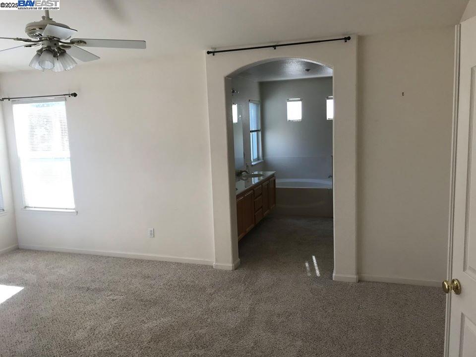 2173 Leafcrest Common Livermore, CA 94551 - Photo 19 of 25 an empty room with a fan and a window