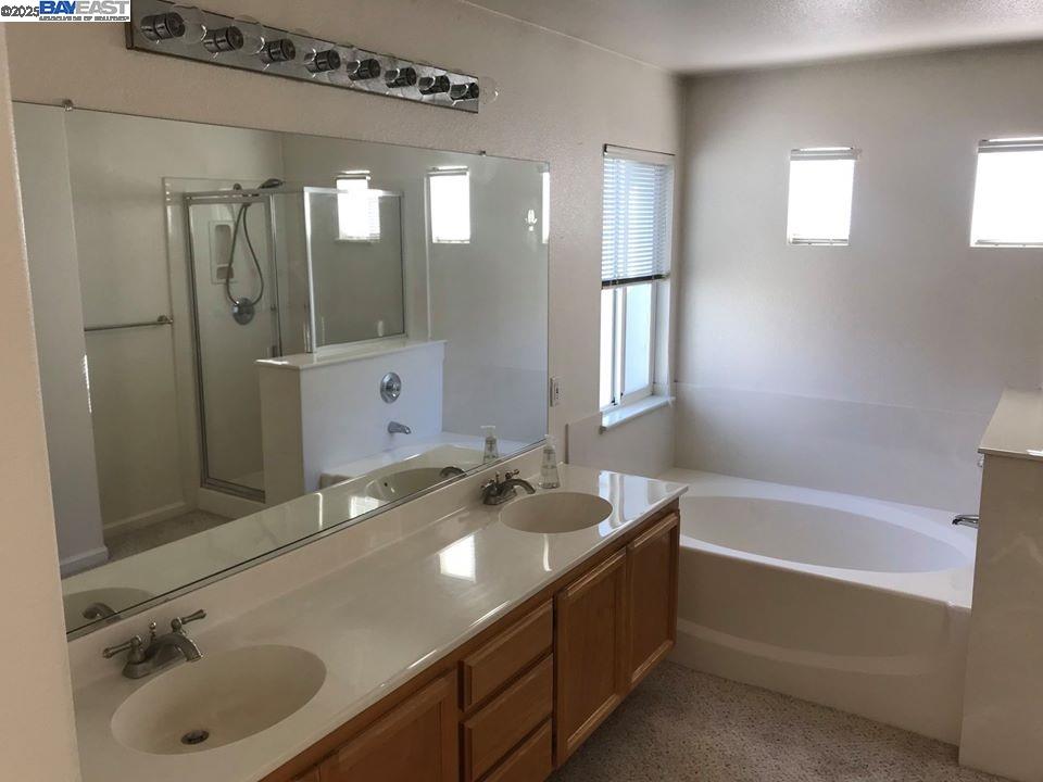 2173 Leafcrest Common Livermore, CA 94551 - Photo 22 of 25 a bathroom with a tub sink and mirror