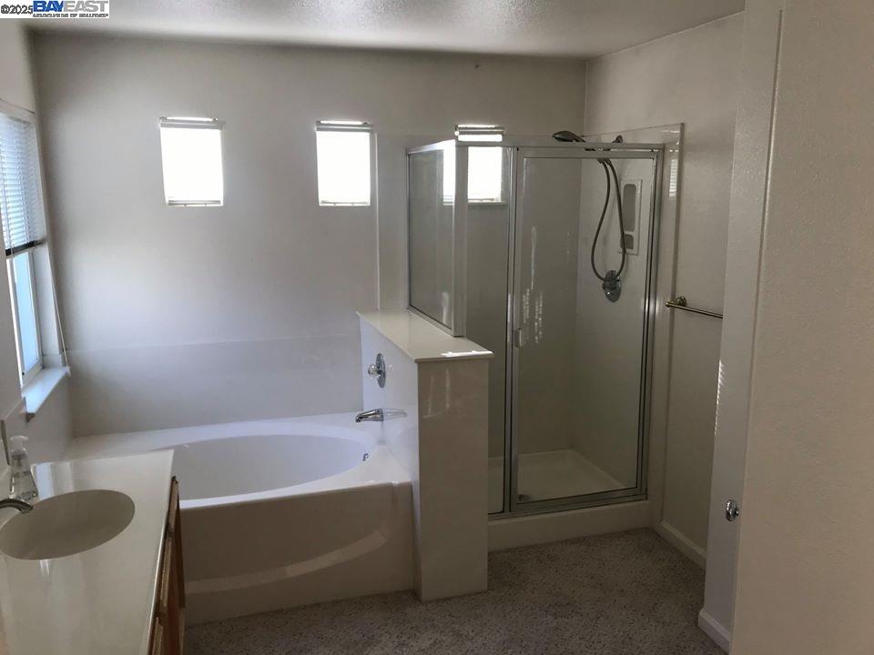 2173 Leafcrest Common Livermore, CA 94551 - Photo 23 of 25 a bathroom with a tub shower sink and vanity