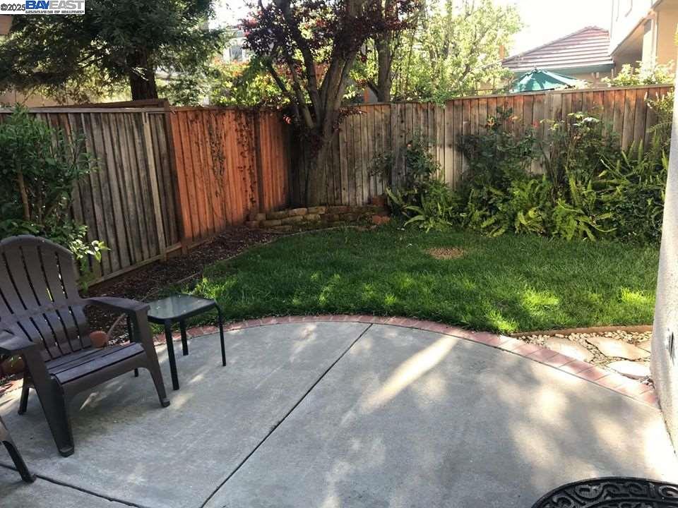 2173 Leafcrest Common Livermore, CA 94551 - Photo 25 of 25 a view of a backyard with chairs potted plants and wooden fence