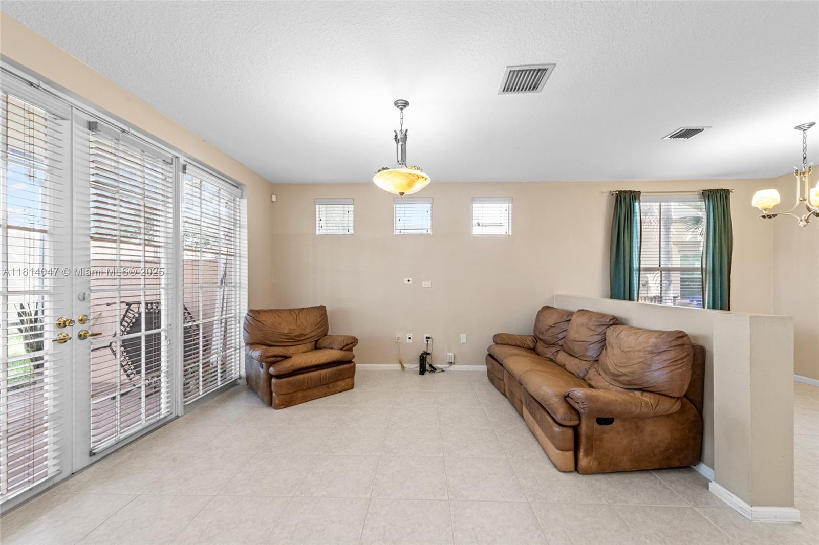 16316 Southwest 48th Street Miramar, FL 33027 - Photo 16 of 37 a living room with furniture and a window