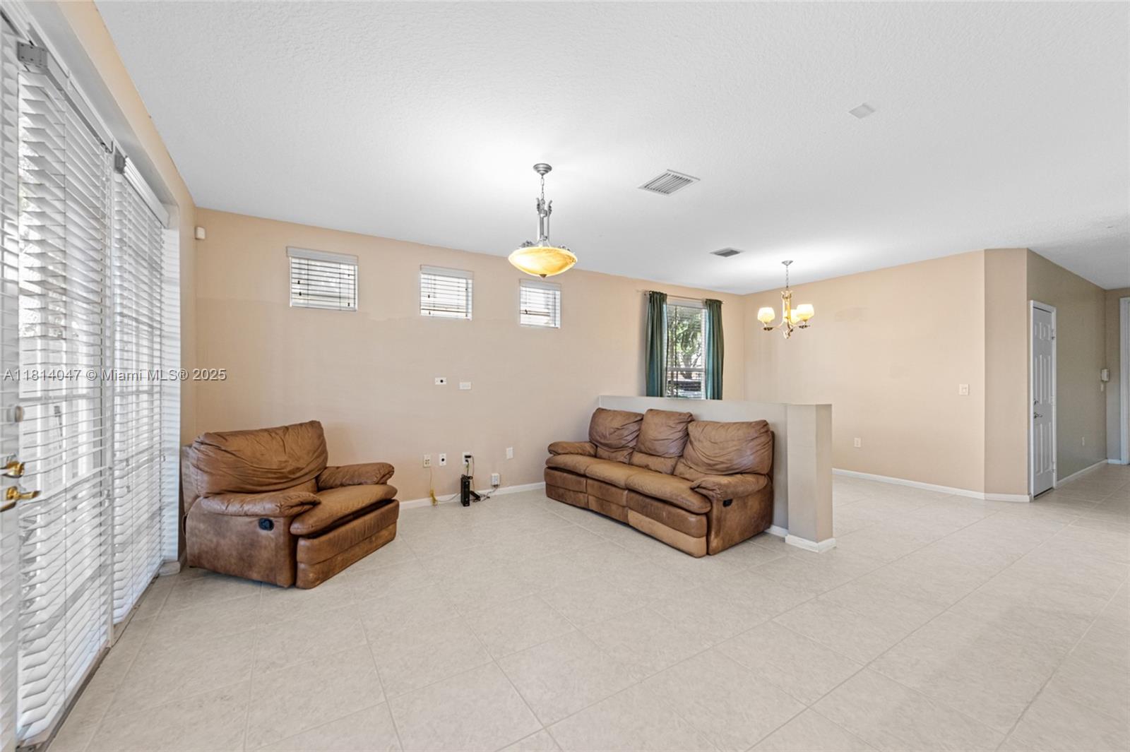 16316 Southwest 48th Street Miramar, FL 33027 - Photo 17 of 37 a living room with furniture gym equipment and a window
