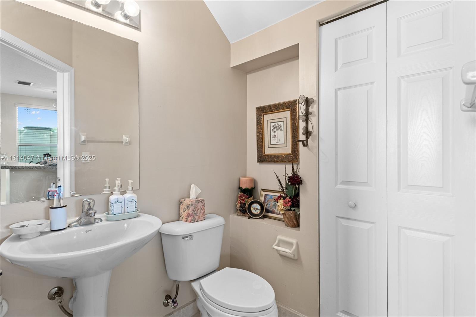 16316 Southwest 48th Street Miramar, FL 33027 - Photo 18 of 37 a bathroom with a sink toilet and a mirror
