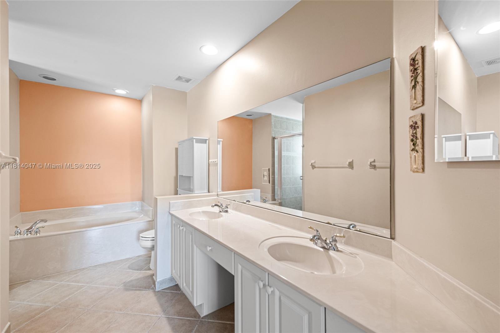 16316 Southwest 48th Street Miramar, FL 33027 - Photo 22 of 37 a bathroom with a tub sink and mirror