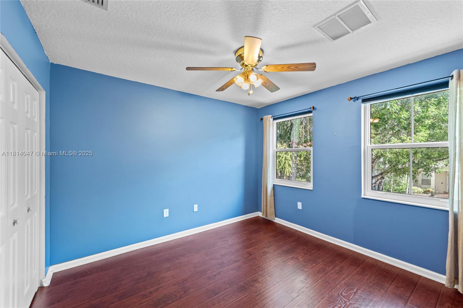16316 Southwest 48th Street Miramar, FL 33027 - Photo 25 of 37 an empty room with windows and chandelier fan