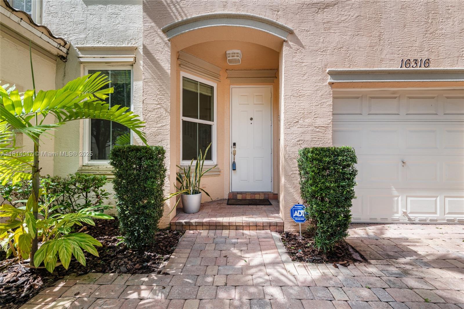 16316 Southwest 48th Street Miramar, FL 33027 - Photo 5 of 37 a front view of a house with garden
