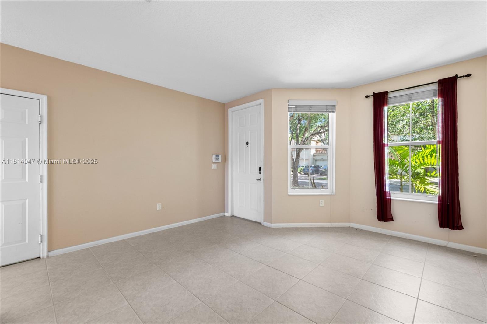 16316 Southwest 48th Street Miramar, FL 33027 - Photo 9 of 37 a view of an empty room with a window