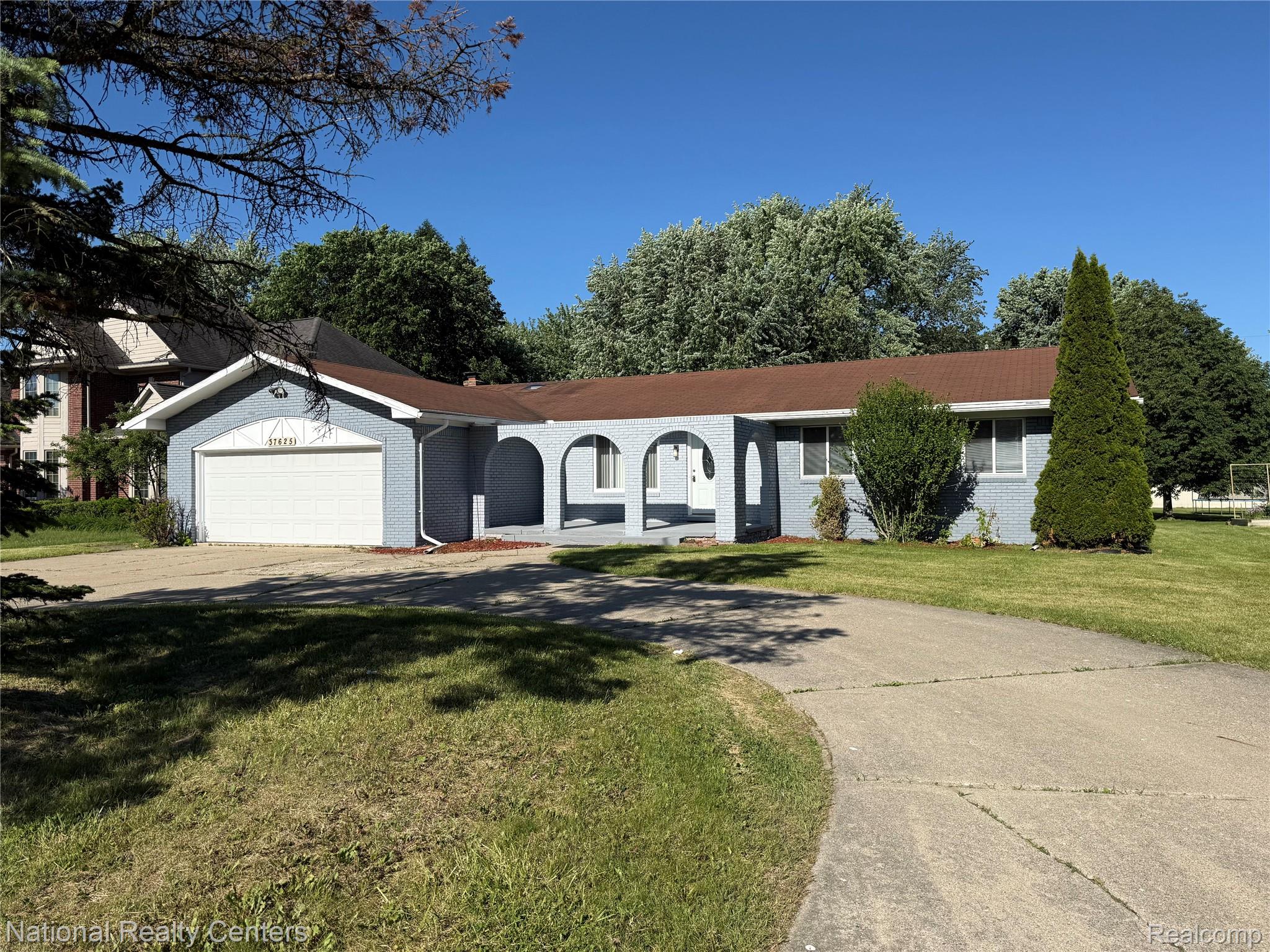 37625 Ryan Road Sterling Heights, MI 48310 - Photo 2 of 30 Single-story residence featuring a light blue exterior, attached garage, and a brown shingle roof