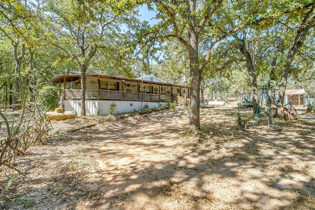 436 Luke Road Springtown, TX 76082 - Photo 6 of 39 View of yard featuring a large porch