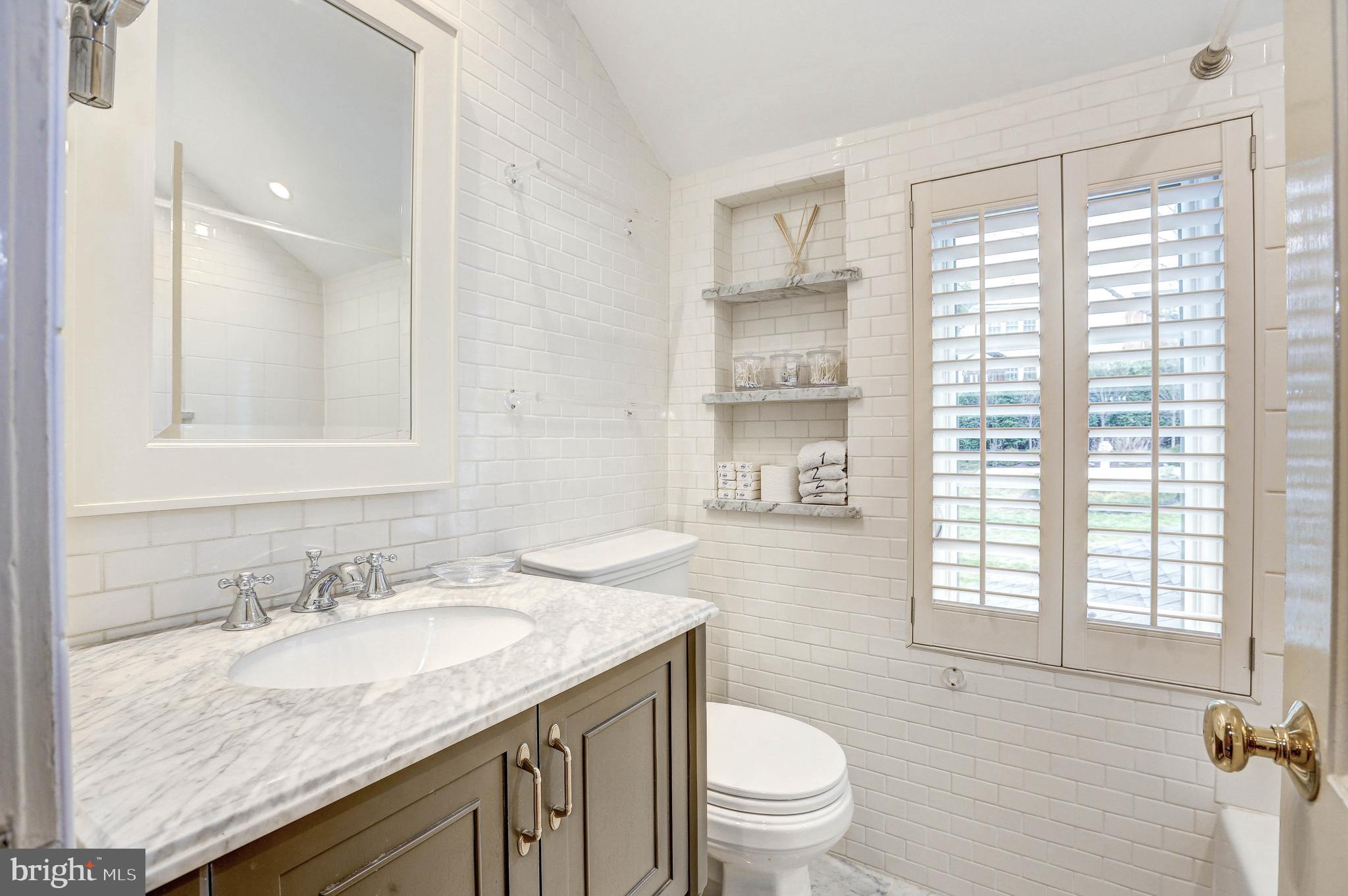 6001 Gloster Road Bethesda, MD 20816 - Photo 42 of 64 Hall bath with marble tile.