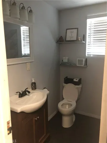 a bathroom with a toilet sink and mirror