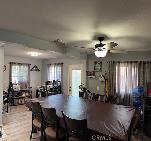 a view of a a dining room with furniture window and wooden floor